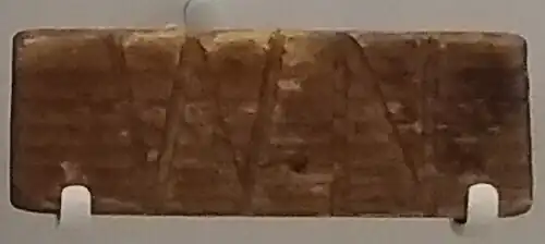 Wooden plaque with the letters "WN" carved in.