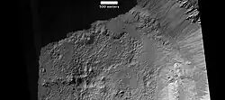 Pits on floor of Resen Crater, as seen by HiRISE. Pits were formed when heat from impact vaporized ice in the ground.