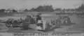 The Battalion's caption reads, "The latest model of military tractors pulled the old howitzers along with the cadets sitting at attention on the cassions."