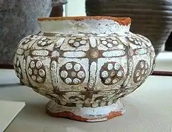 Earthenware bowl decorated with a slip and inlaid with glass paste. 4th-3rd century BCE. British Museum