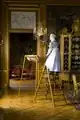 A housemaid cleaning a chandelier with a 'prism trap', early 20th century home museum Stockholm Sweden